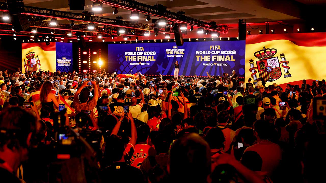 Image of crown cheering at stage as graphics showing Spain progressing to the finals at The World Cup for soccer